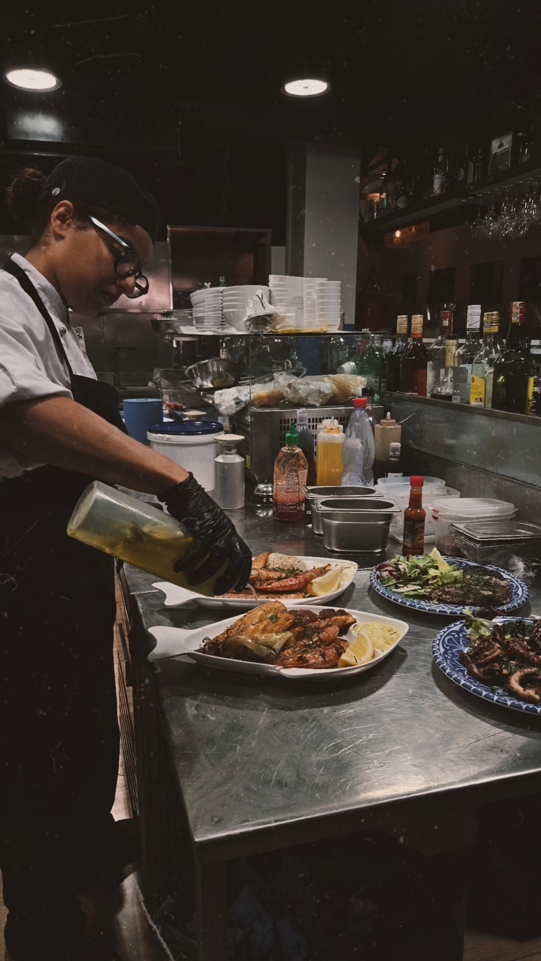 Chef finishing seafood dishes in the kitchen